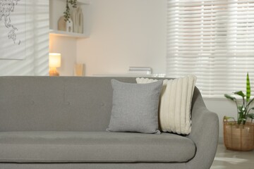 Soft decorative pillows on sofa in room