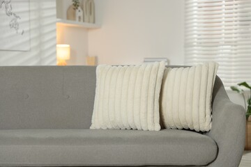 Soft decorative pillows on sofa in room