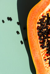Papaya fruit over green background, half of fresh exotic fruits with seeds. Halved fresh organic...