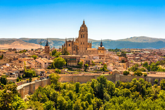 View of Segovia Spain with its Cathedral and wall and the Sierra de Guadarrama in the distance