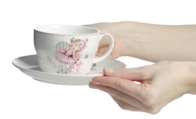 Hand holding kids porcelain floral dishes teacup plate on white background isolation
