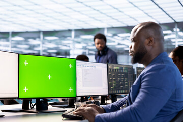 Server room facility admin ensuring data remains shielded from potential threats using mockup PC....