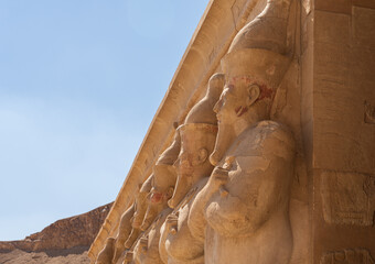 Side view of large statues of pharoahs at Hatshepsut Temple near Luxor Egypt by the columns of the...
