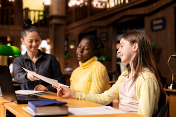 Tutor providing accurate learning materials during academic session with schoolgirls, promoting...
