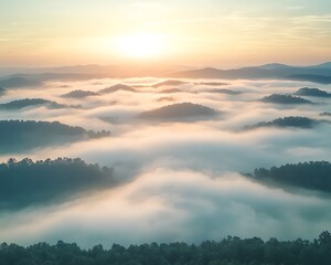 Fototapeta premium Foggy mountain landscape at sunrise with warm sunlight