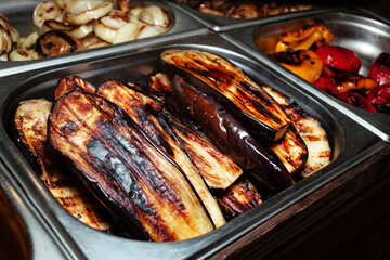Appetizing grilled zucchini. Selling food products at a street fair. Street food to go. Fast food.