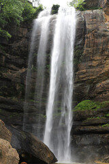 Fototapeta premium Majestic twin waterfalls cascading down a rugged rock face
