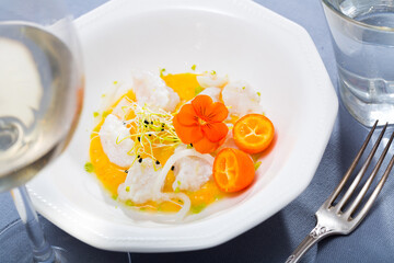 Codfish ceviche with avocado spicy sauce and kumquat served on plate