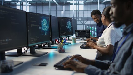IT specialists in data center doing brainstorming, maintaining company network infrastructure. Team...