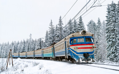 Old soviet regional train with snow-covered trees in the Carpathian Mountains of Ukraine