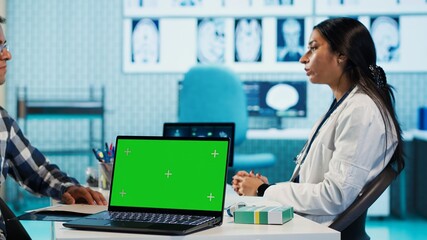 Indian medic consulting her patient in medical facility next to copy space, using advanced technology for scan interpretation and diagnostics. Expert gives advice based on records. Camera A.