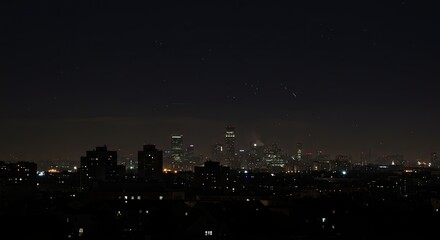 Fototapeta premium City skyline at night with twinkling lights and buildings