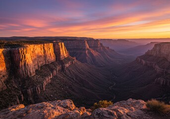 Obraz premium Majestic grand canyon sunset with vibrant sky and deep valleys