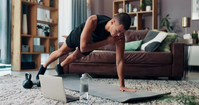 Laptop, fitness and exercise with man in living room for streaming workout class, learning and health. Shoulder taps, wellness and training with person and home gym for sports and virtual course