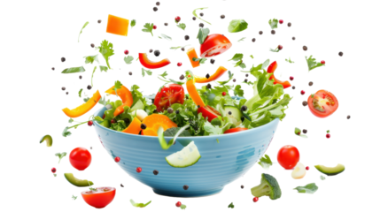 Fresh salad ingredients falling into light blue bowl on transparent background