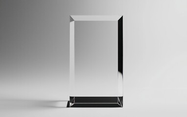 Clear glass rectangular award plaque on a gray background.  The plaque has a dark base and is lit with soft, even light