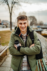 Portrait of young adult man student smiling and listen to music 