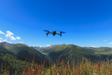 Flying drone in high altitude mountains.