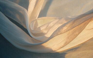 Obraz premium Soft, flowing beige fabric with a textured surface creates elegant, swirling patterns against a dark background. The light catches the fabric, highlighting its delicate texture and translucent