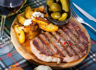 Appetizing beef entrecote with boiled potatoes and pickled cucumbers. High quality photo