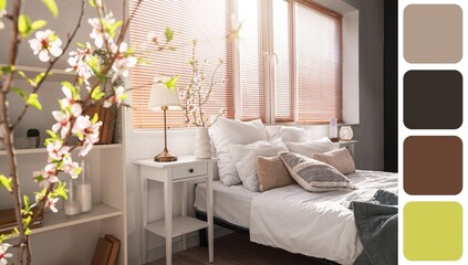 Vase with blooming tree branches in interior of light bedroom. Different color patterns