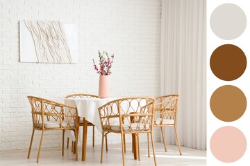 Vase with blooming tree branches on table and armchairs in light dining room. Different color patterns