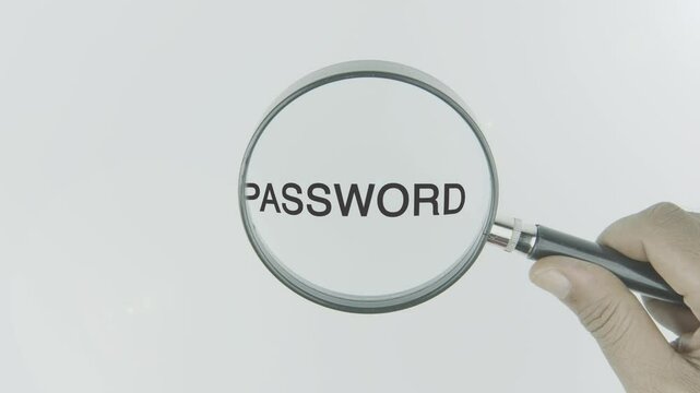 Password text or word highlighted by a magnifying glass in a hand on a white background, symbolizing focus on security, protection, and access control for personal and online accounts