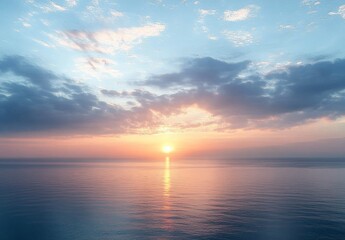 Obraz premium Tranquil Ocean Sunrise with Soft Clouds and Reflective Water Surface Under Gentle Blue and Orange Skies at Dawn
