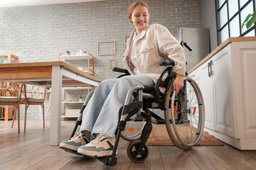 Young redhead woman in wheelchair at home