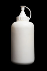 White plastic squeeze bottle with nozzle cap on isolated black background. Refillable plastic dispenser for liquids and chemicals. Hygiene and laboratory concept
