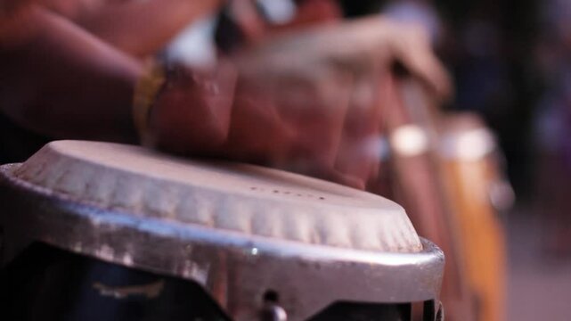 man playing percussion instrument, playing atabaque