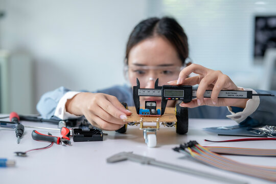 A woman is working on a robot