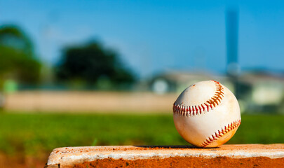 Little League baseball close-up on pitcher's mound with outfield in the background