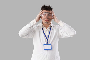Shocked male chemist with burnt face on light background