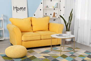 Stylish interior of living room with yellow soft sofa