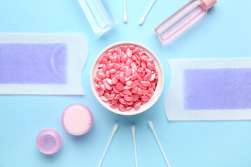Composition with wax and cream for depilation on blue background. Hair removal concept