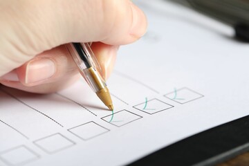 Woman checking box of paper form, closeup