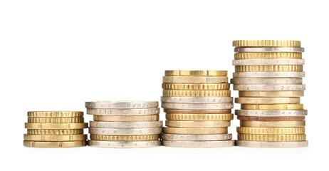 Stacks of different coins isolated on white