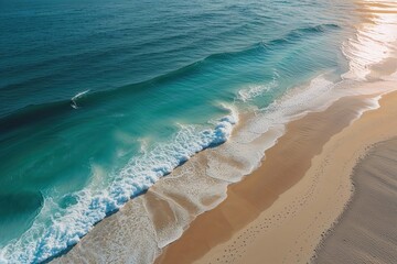 Stunning Drone View of Tan Sand Beach with Tranquil Turquoise Waves and Sunlight Ideal for Summer Travel Ideas