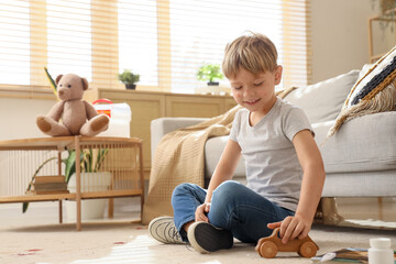 Little boy ill with chickenpox playing at home