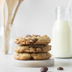 Large chocolate chip cookies on a white countertop, top view of homemade chocolate chip cookies on a white background