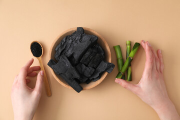 Fresh bamboo shoots with charcoal in a wooden bowl