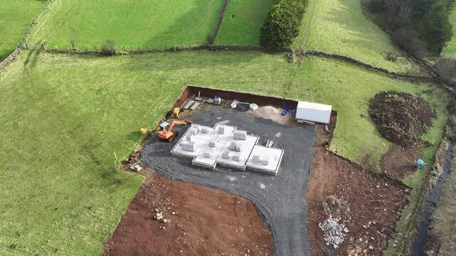 Aerial View of a digger at a building site constructing a new home in UK