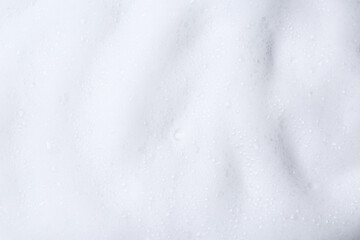 White fluffy foam as background, top view