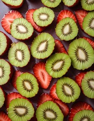 freshly cut kiwi fruit and strawberries on a wooden table