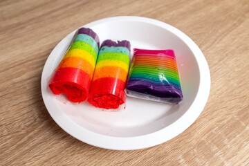 Colorful snacks or cakes on a white plate. Food with artificial coloring or synthetic food dyes.