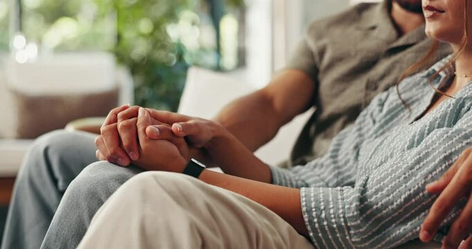 Couple, holding hands and hug for comfort in home, grief and kindness of support with miscarriage. Love, people and together for loss in living room, security and embrace wife for bonding in trauma