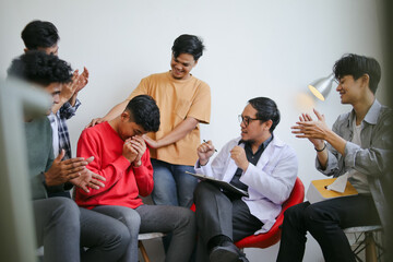 Group Of Diverse People Group Supporting Friend During Therapy Session
