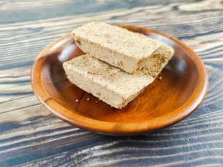 Satru cake, Satu cake, or Koya cake on a wooden table. This traditional Indonesian Javanese pastry is made from processed sago and mung beans.