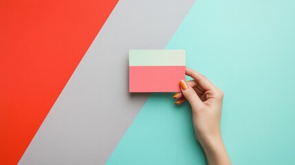 Obraz premium Woman's hand holding card, colorful background, mockup, advertising